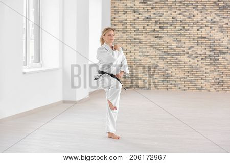 Female karate instructor training in dojo