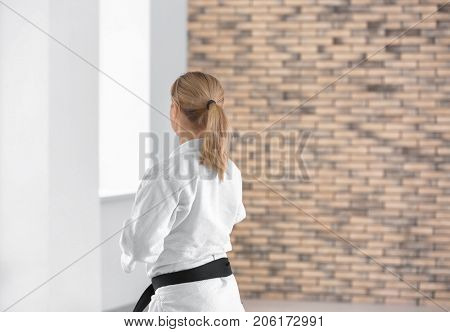 Female karate instructor training in dojo
