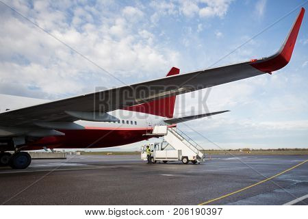 Truck By Gangway Attached To Airplane