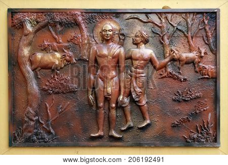 KOLKATA,INDIA - FEBRUARY 09: Bhagavan Mahaviras ears plugged with neddle - like wooden pegs, relief on the wall of Jain Temple (also called Parshwanath Temple) in Kolkata, India on February 09,2016.