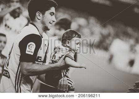 VALENCIA, SPAIN - SEPTEMBER 19: Carlos Soler with a small supporter during Spanish La Liga match between Valencia CF and Malaga CF at Mestalla Stadium on September 19, 2017 in Valencia, Spain