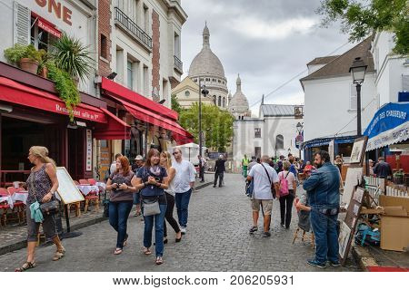 PARIS,FRANCE - JULY 31,2017 : Tourists and artists selling their paintings at the Place du Tertre in Montmartre