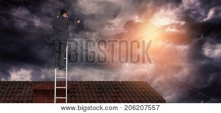 Businessman standing on ladder against gloomy sky