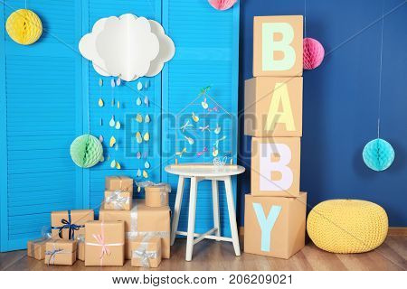 Composition with baby shower decorations and gifts indoors