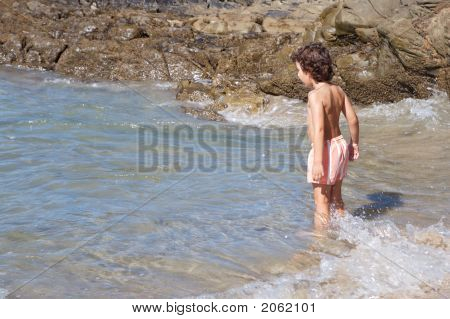 Boy Playing In The Beach