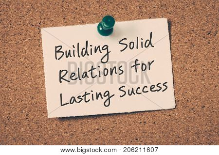 business relationship building reminder message on a cork board
