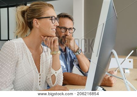 Business people working together on dektop computer