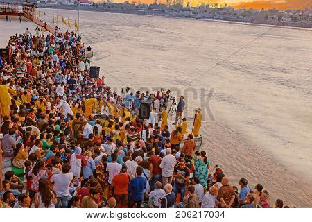RAM JHULA, INDIA - 8th of APRIL 2017: Puja celebration at the banks of the Ganga in Ram Jhula, India on the 8th of april 2017 at sunset