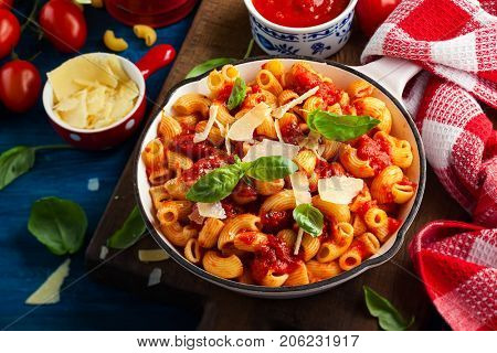 Pasta with spicy tomato sauce, parmesan and basil. Pasta Chifferi Rigati.