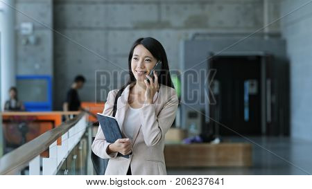 Business woman holding tablet computer and talk to mobile phone 