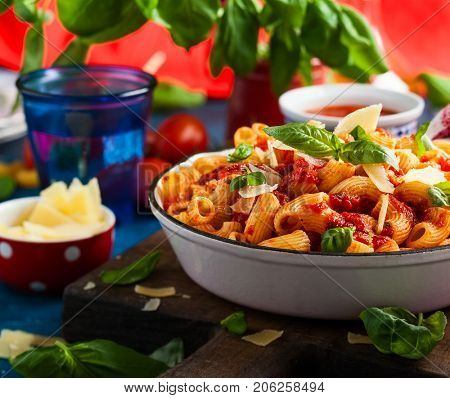 Pasta with spicy tomato sauce, parmesan and basil. Pasta Chifferi Rigati.