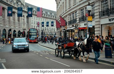 LONDON, UK - SEP 27: Piccadilly Circus street view on September 27, 2013 in London, UK. Built in 1819, it is the major shopping, entertainment areas and key tourist attractions in London.