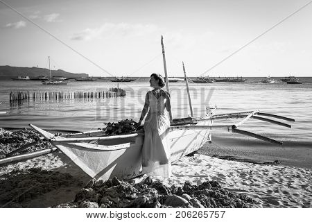 BORACAY, PHILIPHINES- MARCH 17, 2017: Beautiful asian bride posing on a boat by the sea. Boracay on March 17, 2017. Philiphines.