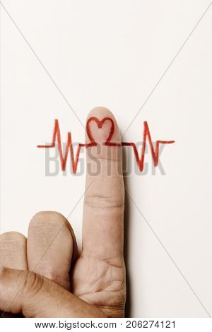 a red heart symbol in the forefinger of a man as in an electrocardiogram painted on an off-white background, with a blank space on top