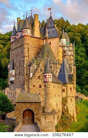 Burg Eltz castle in Rhineland-Palatinate state at sunset, Germany. Construction started	prior to 1157.