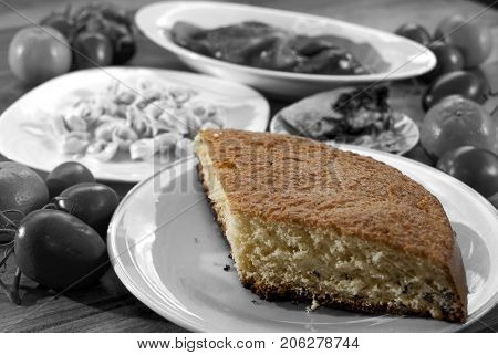 chocolate sponge cake between other black and white dishes