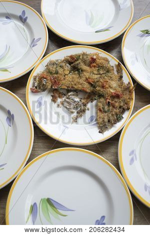 baked anchovy pie au gratin between a series of white dishes