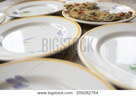 baked anchovy pie au gratin between a series of white dishes