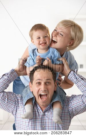 Excited happy family having fun together at home, laughing.