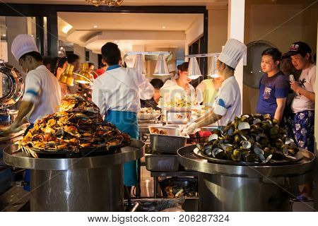 BORACAY, PHILIPHINES-MARCH 17, 2017:Group of chef preparing food in the kitchen of a public restaurant on March 17, 2017. Boracay, Philiphines.