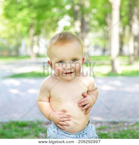 little boy walking outdoor. Child playing in summer park, image toned, soft focus