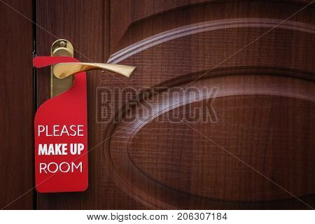 Closed door with sign PLEASE MAKE UP ROOM on handle at hotel