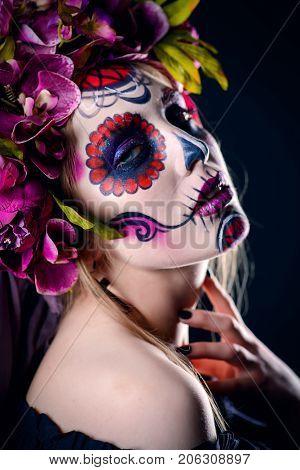 Closeup portrait of Calavera Catrina. Young woman with sugar skull makeup. Dia de los muertos. Day of The Dead. Halloween.