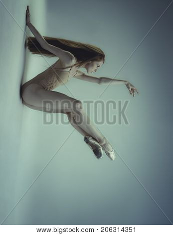 Moving, Beautiful ballet dancer with colored flesh jersey, classical dance poses