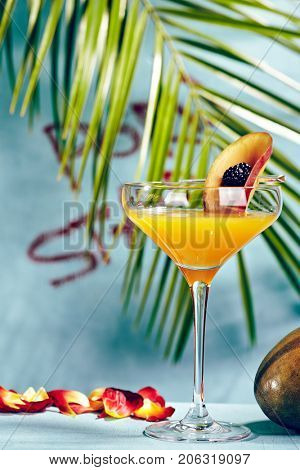 Summer  Cocktail -  Pornstar Martini. Drink with Passion fruit, Vodka, Liquor, Vanilla Syrup, Champagne and Lime Juice. Tropical Leaf on Background