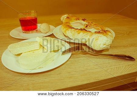 Adjarian khachapuri close-up. This traditional georgian dish contains brinsen cheese butter and row egg. Khachapuri on ajarski - recipe of Georgian cuisine - Retro color