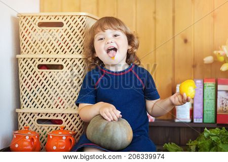 Little girl eating in the kitchen. Portrait.