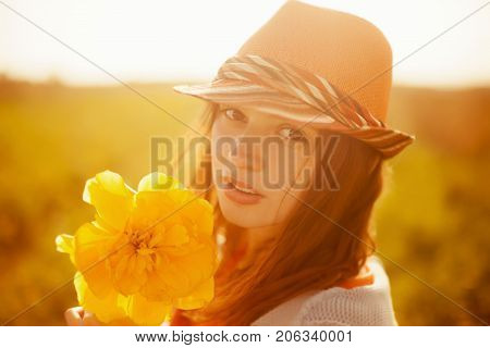 Young attractive romantic girl with big tulip flower.