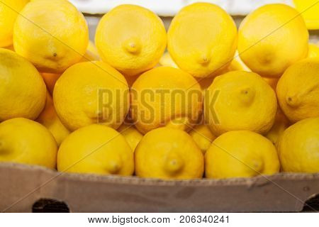 Lemons in the box closeup, farmer  market.