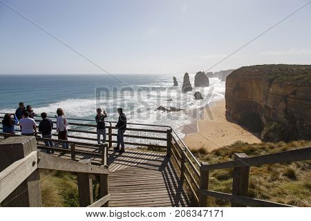 Melbourne, Australia: October 8, 2015: Tourists look enjoy the Twelve Apostle Sea Rocks from the viewing boardwalk provided and maintained by the Port Campbell National Park.
