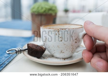 An empty cup of coffee on a wooden table. Hot drink in the morning