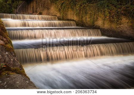 The spillway on the Lower Lliedi reservoir in Swiss Valley, Llanelli, South Wales UK