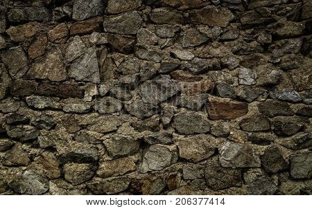 Brown stone wall. Stone background. Stone texture.Old stone style. Grunge stone. Grunge brown stone background.  Wall of the old fortification in Ust-Kamenogorsk.