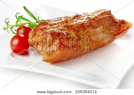 Baked pork roast with tomato, on white background