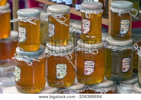 TIMISOARA ROMANIA - SEPTEMBER 24 2017: Glass jars of honey overlapping and exposed for sale at a traditional fair known as the 