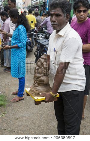 Close up of hand crafted Ganesha idol clay statues displayed in the market during Ganesh Festival.