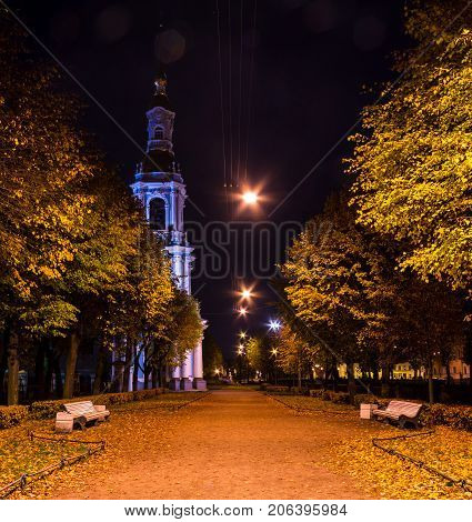 Night autumn view of illuminated St. Nicholas Naval Cathedral and alley in Nikolskiy garden St. Petersburg Russia