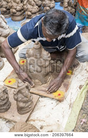 Close up of hand crafted Ganesha idol clay statues displayed in the market during Ganesh Festival.