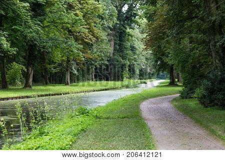 Forest landscape : quiet river flows in the old deciduous park Schoenbusch ( Schönbuch ) - english landscape garden Aschaffenburg Germany