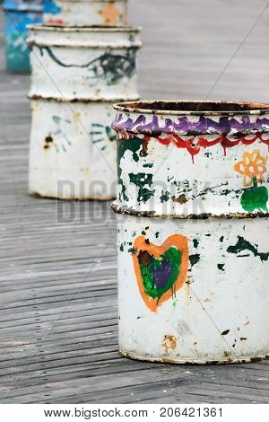 Hand Painted Barrels On A Lined Up On A Boardwalk