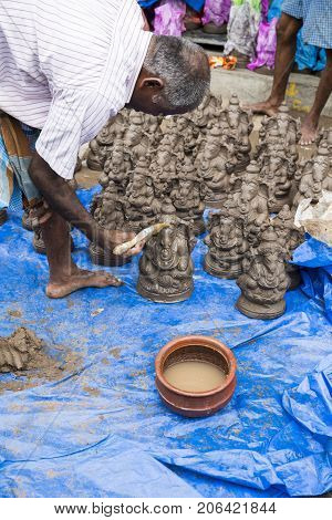 Close up of hand crafted Ganesha idol clay statues displayed in the market during Ganesh Festival.