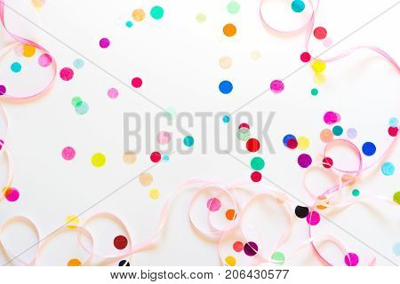 Festive party or carnival confetti on pink background