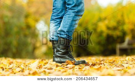 Nature outdoor foliage relax concept. Man in black boots. Male in leather footwear jeans trousers standing outside.