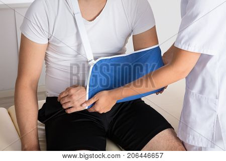 Close-up Of A Doctor Examining Injured Man's Hand In Clinic