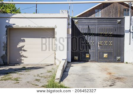Iron gate to the entrance to the garage and cottage