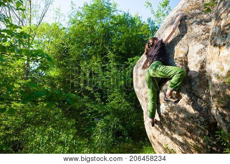 Climber Is Bouldering Outdoors.